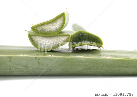 Fresh Aloe Vera Slices Displaying Gel Texture on White Background 130913788