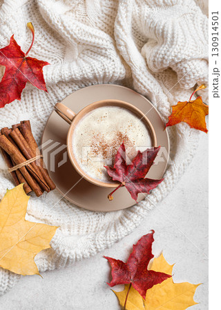 Autumn latte coffee with maple leaves and cozy plaid Autumn latte coffee with maple leaves and cozy plaid 130914501