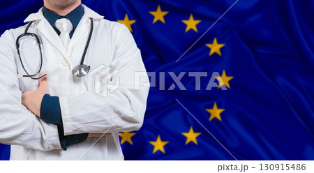 Male doctor with stethoscope on European Union flag. Doctor holding stethoscope on European Union flag 130915486