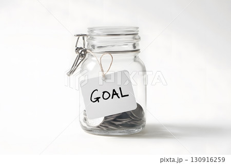 Coins in glass jar show money goal being saved for future. Coins in glass jar show money goal being saved for future. 130916259