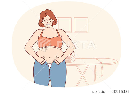 Woman experiencing problems with excess weight tries to put on small pants, and needs diet or fitnes 130916381