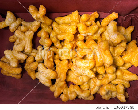 Chinese bread stick are on tray at hotel in breakfast time. This menu usually eat in morning with hot coffee or chocolate and sweetened condensed milk or steamed custard. Top view 130917389