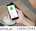 Closeup hand holding a smartphone. The phone show a payment form on its screen. 130917543