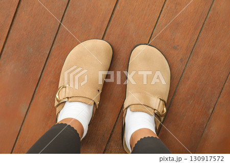 Enjoying a moment of relaxation while wearing cozy travel shoes Enjoying a moment of relaxation while wearing cozy travel shoes 130917572