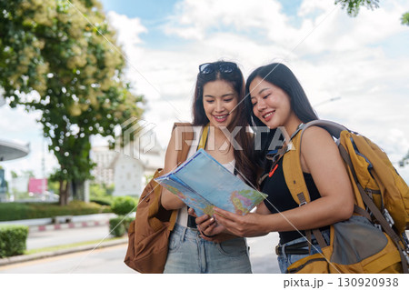 Friends Enjoying Day Out with Map in City 130920938