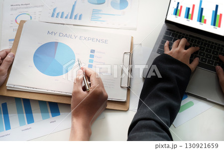 Expense Management. Individual analyzing daily expenses with a report. 130921659