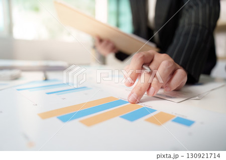 Financial Analysis. Business professional pointing at growth charts. Financial Analysis. Business professional pointing at growth charts. 130921714