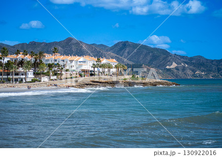 NERJA, SPAIN - MARCH 22, 2025: Wonderful landscapes of the shimmering sea and charming city unfold, offering breathtaking coastal views and a picturesque atmosphere in Nerja, Spain on March 22, 2025 NERJA, SPAIN - MARCH 22, 2025: Wonderful landscapes of the shimmering sea and charming city unfold, offering breathtaking coastal views and a picturesque atmosphere in Nerja, Spain on March 22, 2025 130922016
