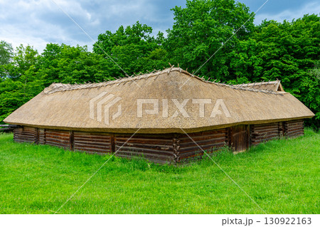 A typical Ukrainian ancient house covered with straw stands quietly, reflecting traditional rural architecture and cultural heritage in Ukraine. A typical Ukrainian ancient house covered with straw stands quietly, reflecting traditional rural architecture and cultural heritage in Ukraine. 130922163