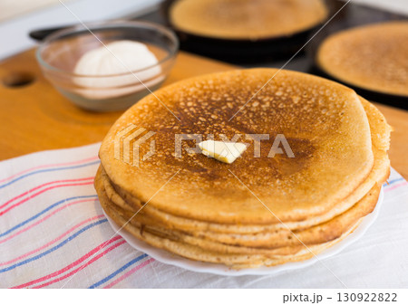 stack of appetizing flour pancakes in the kitchen during cooking stack of appetizing flour pancakes in the kitchen during cooking 130922822