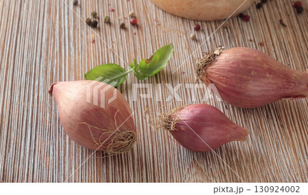 Shallots on wooden cutting board. Food and cooking. Healthy eating and organic products. 130924002