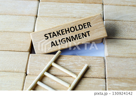 Shareholder Alignment text on wooden blocks representing business concept and stakeholder expectation. 130924142