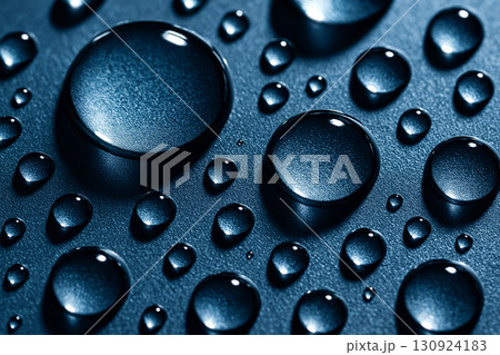 Enlarged closeup of water droplets on a bluish surface with sharp reflective highlights. Enlarged closeup of water droplets on a bluish surface with sharp reflective highlights. 130924183