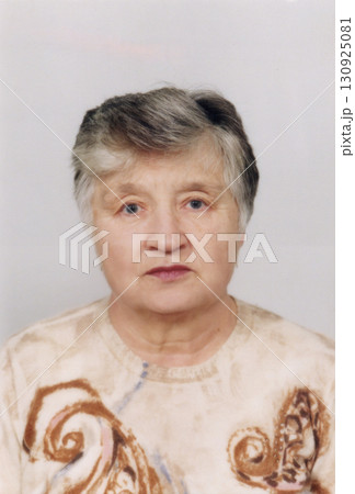 A portrait of a beautiful, gray-haired seventy-five-year-old woman. The woman is serious and self-confident. A portrait of a beautiful, gray-haired seventy-five-year-old woman. The woman is serious and self-confident. 130925081