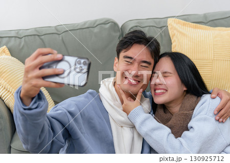 Winter provides cozy home for happy couple, people enjoy indoor family time with loved ones, selfie moment captures pure joy, creating warm beautiful winter memories together. Winter provides cozy home for happy couple, people enjoy indoor family time with loved ones, selfie moment captures pure joy, creating warm beautiful winter memories together. 130925712