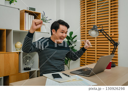 success woman working with laptop computer at home office 130926298