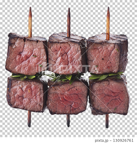A Juicy grilled beef skewers with herbs, showcasing perfectly cooked medium rare meat. skewers are arranged vertically, highlighting texture and succulence of beef 130926761
