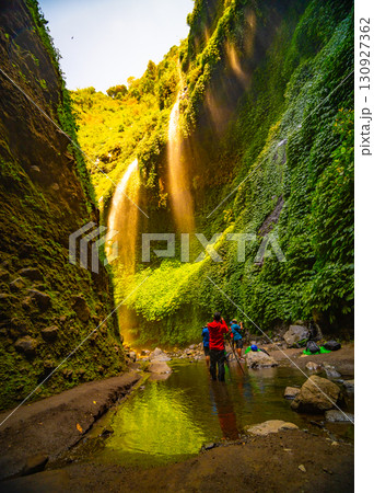 Beautiful waterfalls in sunny day,Bottom view Madakaripura Waterfall is the tallest waterfall in East Java, Indonesia Beautiful waterfalls in sunny day,Bottom view Madakaripura Waterfall is the tallest waterfall in East Java, Indonesia 130927362