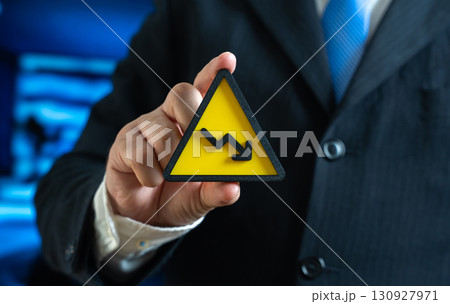 A symbol of falling income in the hands of a businessman. Crisis and financial problems. Staff reduction and decreased investment activity. Symbol of economic downturn, instability, risks A symbol of falling income in the hands of a businessman. Crisis and financial problems. Staff reduction and decreased investment activity. Symbol of economic downturn, instability, risks 130927971