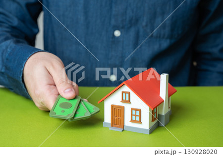 The man pays rent for housing. Payment of bills and utilities. Symbol of family budget, property expenses, household management and financial responsibility in everyday life. 130928020