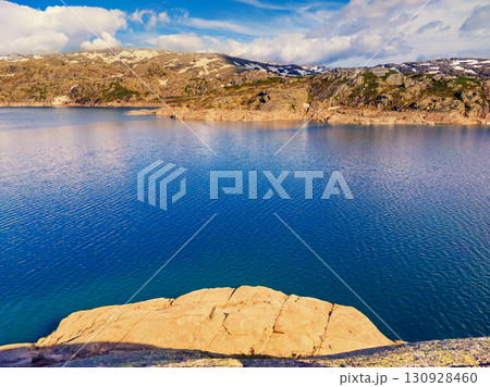 Panoramic view of the valley with mountain lake. Lake Svartavatnet in the mountains in summer. Natural park in the municipality of Sauda. The beautiful nature of Norway 130928460