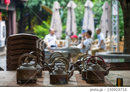 Teapots on a table with a relaxing outdoor ambiance Teapots on a table with a relaxing outdoor ambiance 130928718
