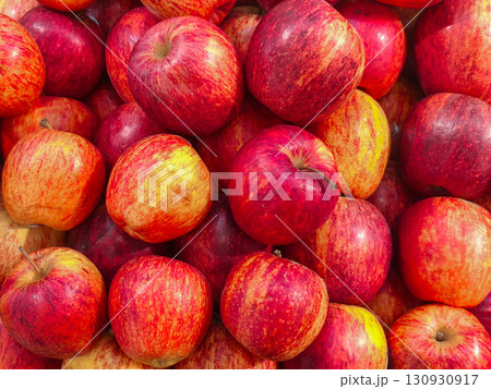 Fresh red apples piled together, showing vibrant colors and natural textures, perfect for healthy food, market, and agriculture concepts. Fresh red apples piled together, showing vibrant colors and natural textures, perfect for healthy food, market, and agriculture concepts. 130930917