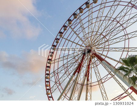 Shot of the ferris wheel, cloudy sky on the background 130931024