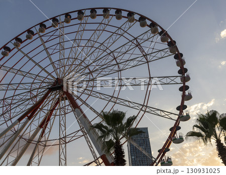 Shot of the ferris wheel, cloudy sky on the background 130931025