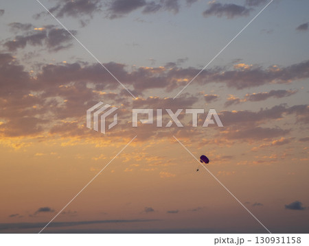 Shot of the person parasailing during sunset hour Shot of the person parasailing during sunset hour 130931158