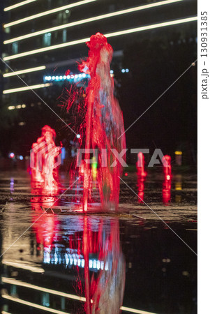 Colorful Illuminated fountains in the dark in the park 130931385