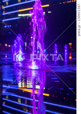 Colorful Illuminated fountains in the dark in the park Colorful Illuminated fountains in the dark in the park 130931387