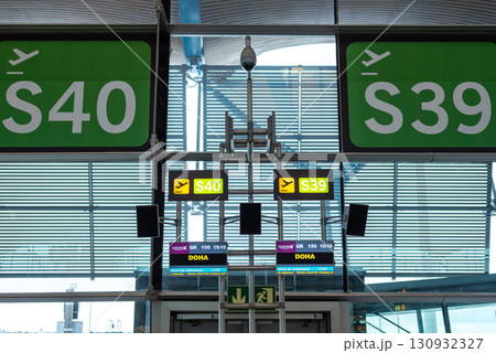 Airport departure gates with flight information to Doha, Qatar in Madrid Barajas International Airport in Madrid, Spain Airport departure gates with flight information to Doha, Qatar in Madrid Barajas International Airport in Madrid, Spain 130932327