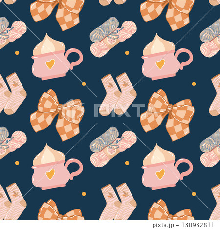 A cozy seamless pattern for girls and women with autumn attributes. A cup, yarn, bow, and socks. Vector flat illustration in pink and brown shades on a dark blue background. 130932811