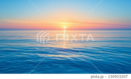 Sunset over the sea, soft sky as the sun descends, its light casting a path across the calm waters 130933207