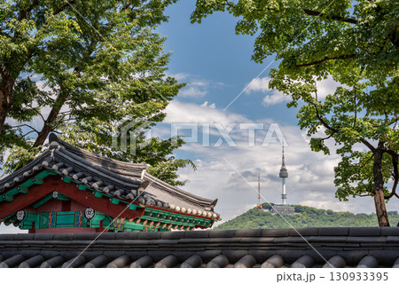 Traditional Korean Hanok roof with Namsan Tower in the background, in Yongsan district of Seoul, capital of South Korea Traditional Korean Hanok roof with Namsan Tower in the background, in Yongsan district of Seoul, capital of South Korea 130933395