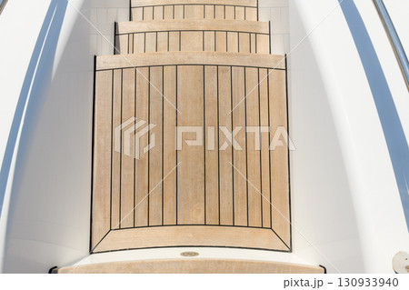 Teak stairs ladder on luxury yacht. Elements of yacht construction. Superyacht concept. Teak stairs ladder on luxury yacht. Elements of yacht construction. Superyacht concept. 130933940