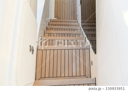 Teak stairs ladder on luxury yacht. Elements of yacht construction. Superyacht concept. Teak stairs ladder on luxury yacht. Elements of yacht construction. Superyacht concept. 130933951