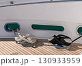 Bollard (cleat) with mooring line on superyacht. Mooring gear on yacht. Superyacht equipment. Side view. 130933959