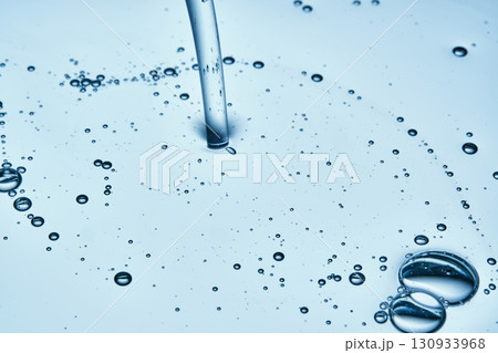 The texture of hyaluronic cleansing for the face or serum in blue tones. The texture of hyaluronic cleansing for the face or serum in blue tones. 130933968