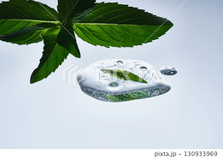 A drop of natural cosmetics with a mint leaf. 130933969