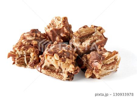 pieces broken chocolate caramel wafer bar with nuts isolated on white background pieces broken chocolate caramel wafer bar with nuts isolated on white background 130933978