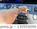 A close up view of a yacht or ship bridge with a captains hand operating the throttle controls. 130934006