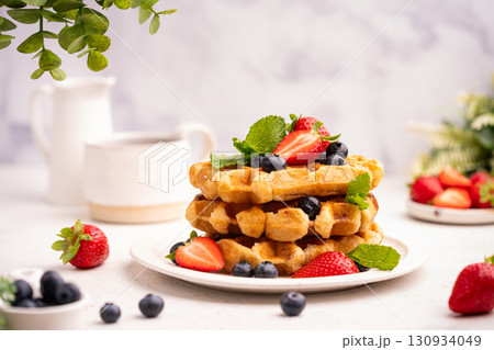 Tasty Belgian waffles with fresh berries 130934049