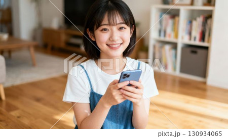 スマートフォンを持って笑う若い女性 スマートフォンを持って笑う若い女性 130934065