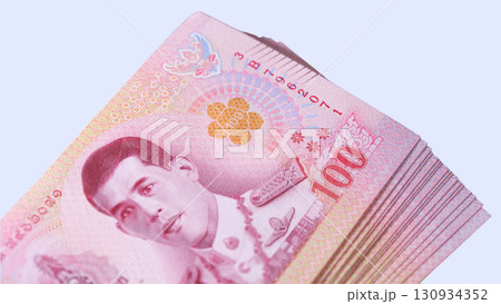 Close-up view of a laptop with black keyboard and reflective surface in a dimly lit environment 130934352