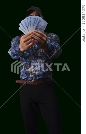 Currency details showcasing intricate designs and patterns of banknotes used in everyday transactions in a market setting Currency details showcasing intricate designs and patterns of banknotes used in everyday transactions in a market setting 130934379