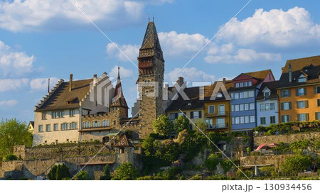 Historic buildings and tower in a picturesque landscape under a blue sky with clouds Historic buildings and tower in a picturesque landscape under a blue sky with clouds 130934456