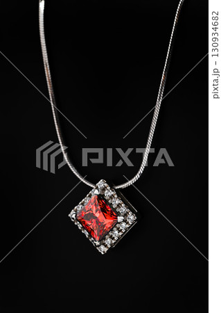 A white gold necklace with a red gemstone pendant A white gold necklace with a red gemstone pendant 130934682