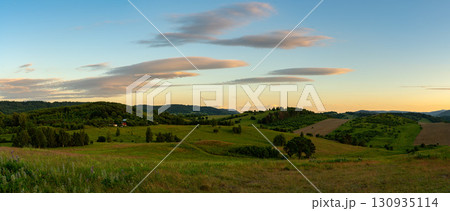Landscape of the hills on the outskirts of Kamienna Gora during beautiful sunset on a summer afternoon, Lower Silesia, Poland. Landscape of the hills on the outskirts of Kamienna Gora during beautiful sunset on a summer afternoon, Lower Silesia, Poland. 130935114